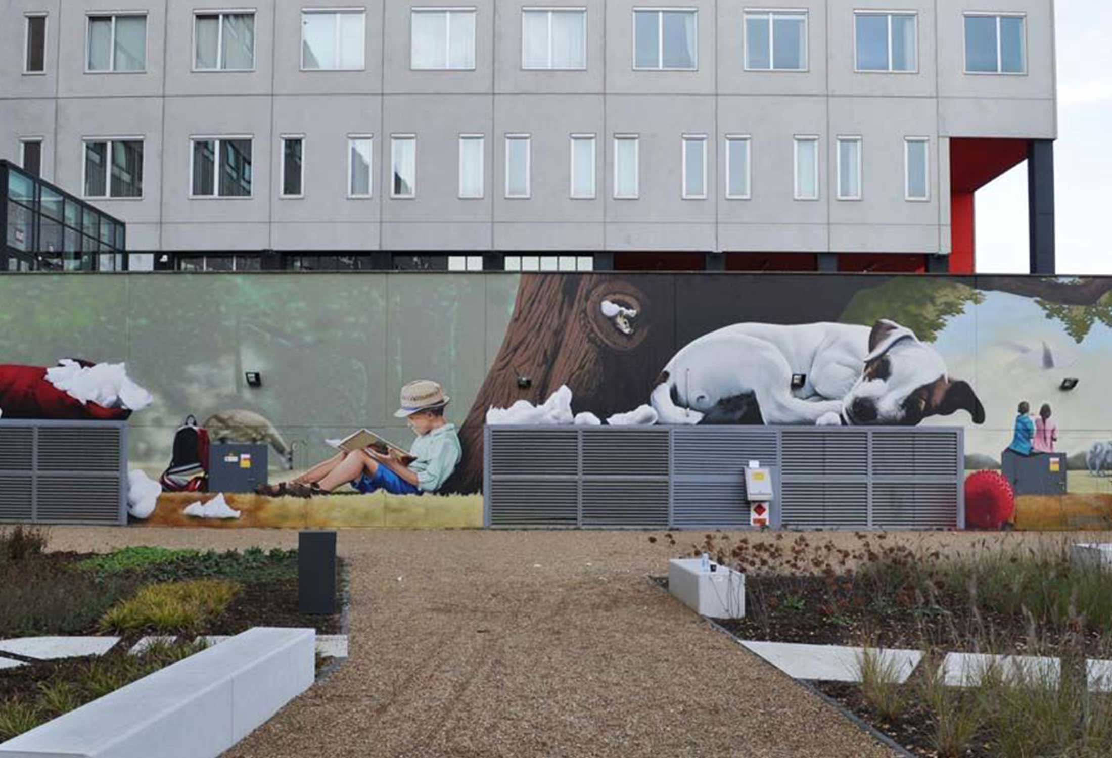 Bart Smeets used the magic of art in public places to transform an office space outdoor area into a relaxing retreat with a beautiful mural that boosts the value of the rental property