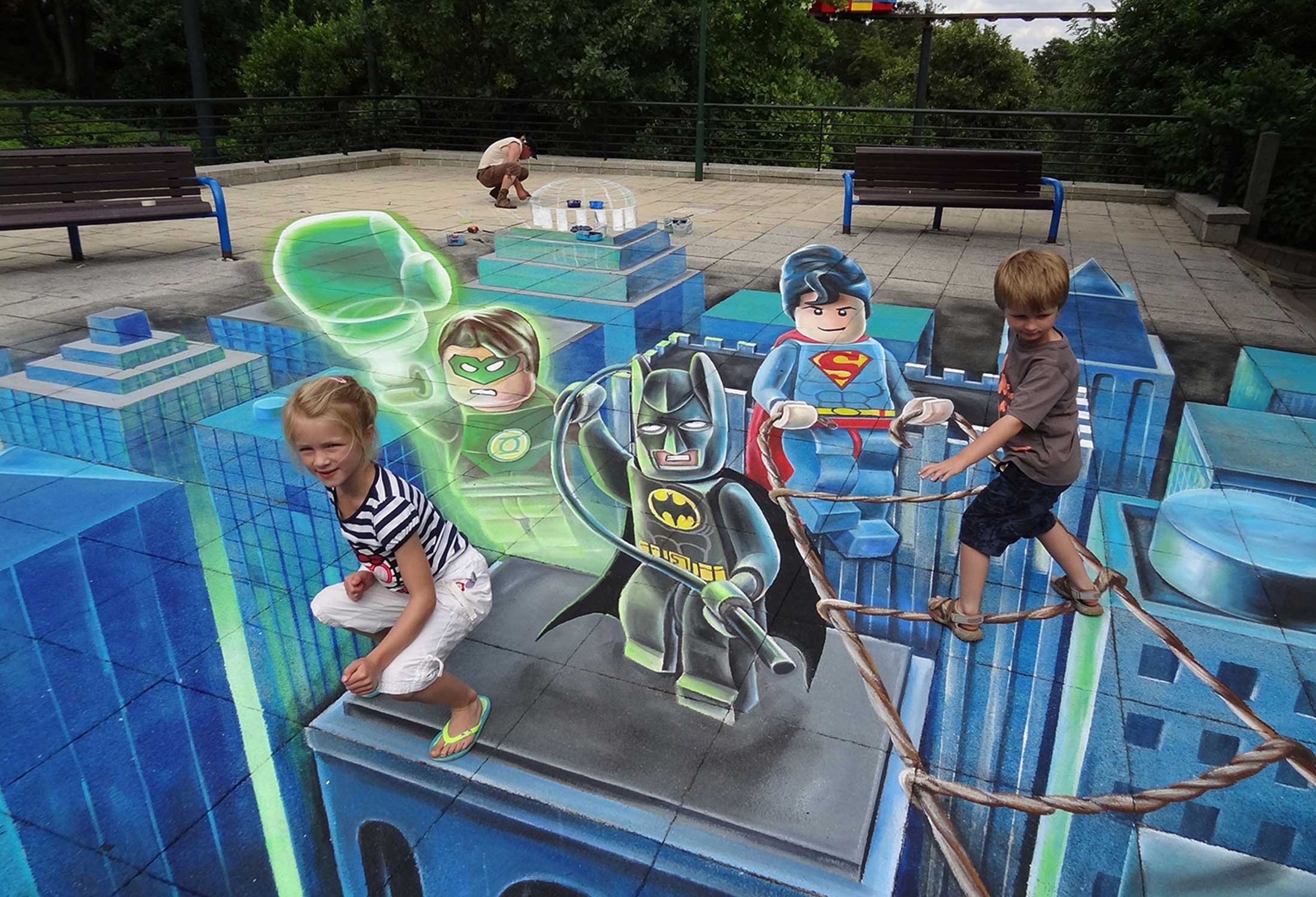3D urban art by Leon Keer featuring Lego Batman, Lego Superman, and Lego Green Lantern
