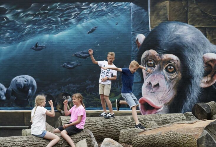 A magical and memorable mural by Tasso at Odense Zoo in Denmark that shows several animals.