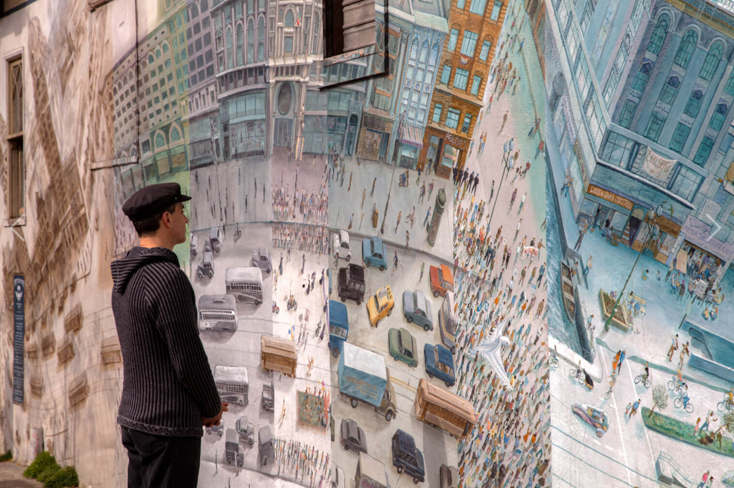 A viewer analyzing Mona Caron’s Market Street Railway mural