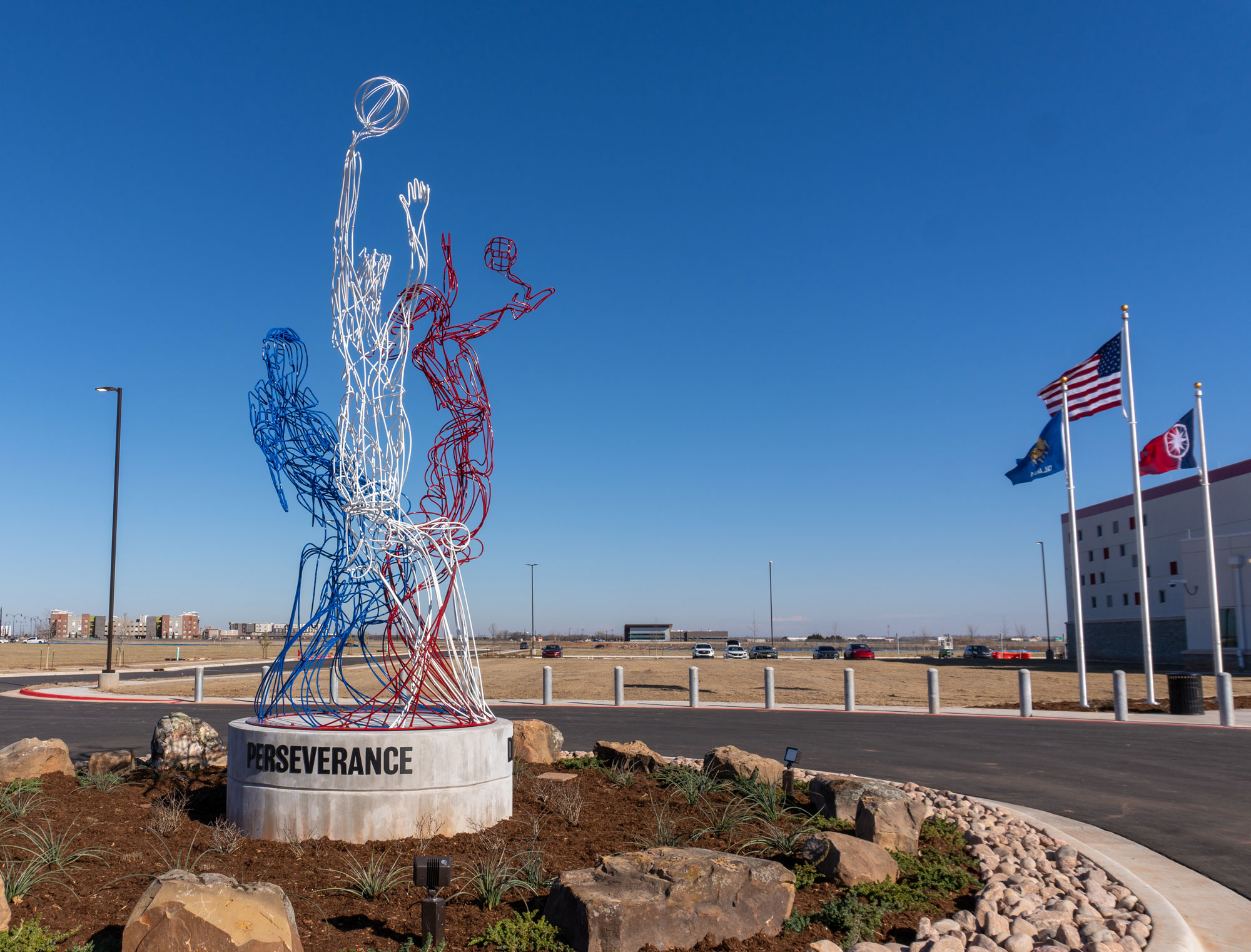 The figures represent the three different sports offered at the center and the color palette reflects the local community of Norman, OK, making this sculpture a unique, site-specific landmark.