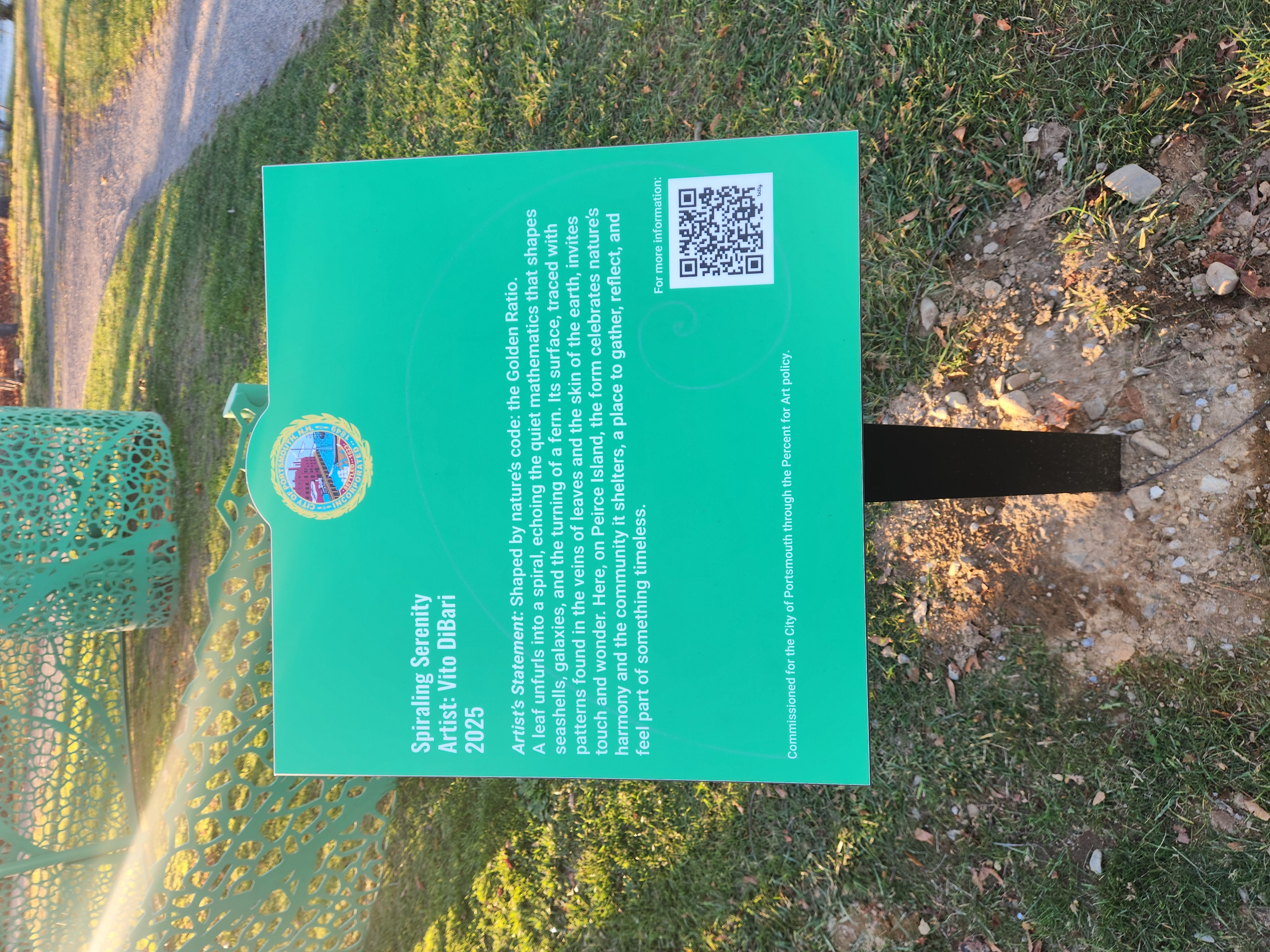 “Shaped by nature's code.” The official dedication plaque for “Spiraling Serenity” on Peirce Island invites visitors to gather and reflect.