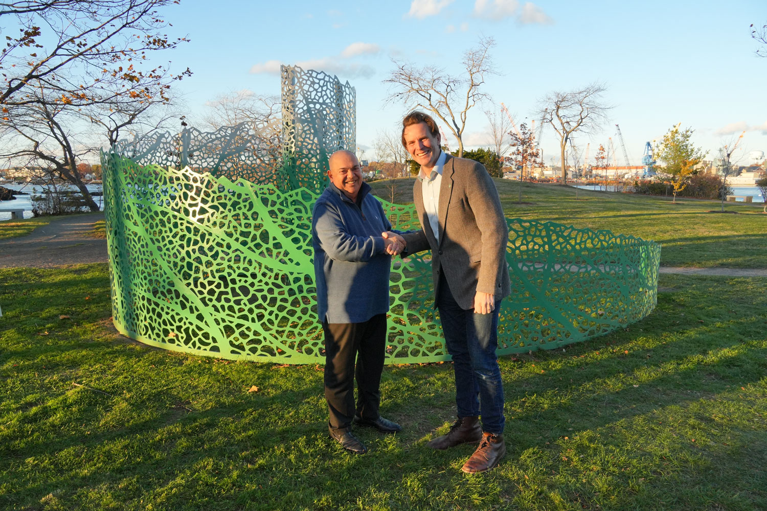 Artist Vito Di Bari (left) and Deaglan McEachern, Mayor of Portsmouth, (right) stand before the newly unveiled “Spiraling Serenity” on Peirce Island, celebrating a landmark that weaves together nature's geometry and the spirit of the city.